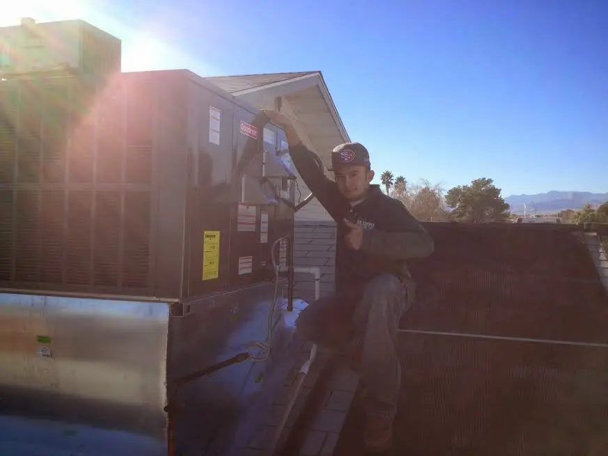 HVAC technician performing Heat Pump Repair on a rooftop unit in Rotonda